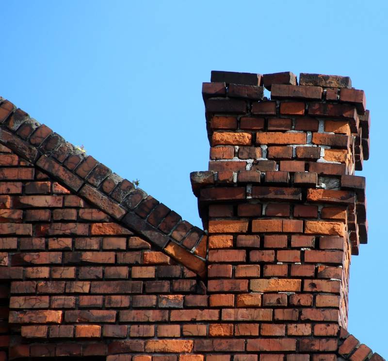 Damaged chimney on an Severna Park home showing cracks and missing mortar